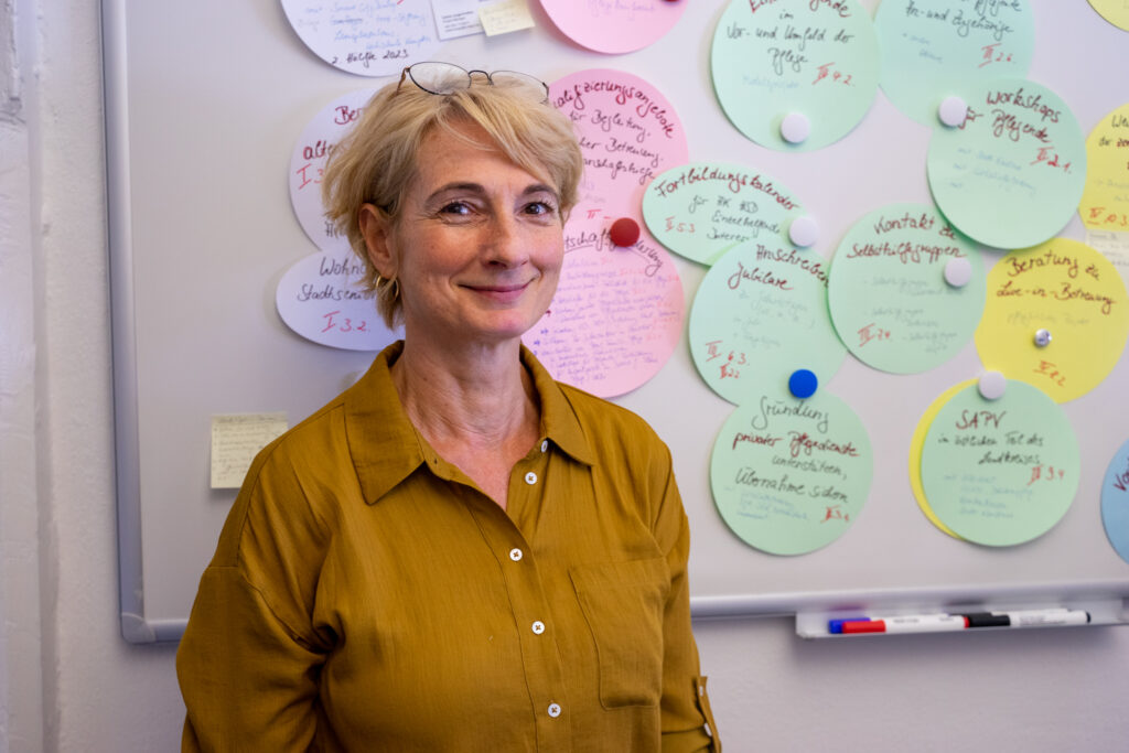Petra Böhrer steht in ihrem Büro im Sozial- und Jugendamt (SJA) vor einer Pinnwand mit vollgeschriebenen Zetteln zum Handlungsprogramm.